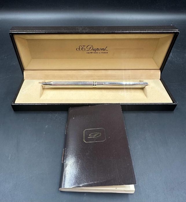 An S T Dupont silver ballpoint pen, boxed.