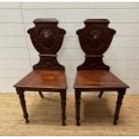 A pair of shield back 19th Century mahogany hall chairs