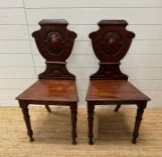 A pair of shield back 19th Century mahogany hall chairs