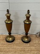 A pair of trophy style metal lamps