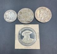 A selection of USA Coins to include: 1923 dollar, 1926 dollar, 1942 half dollar, Leavenworth