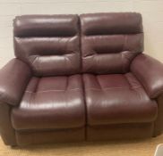 A burgundy leather two seater sofa by Lazyboy