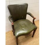 A mahogany and leather desk chairs