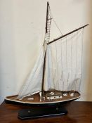 A model of a racing yacht on blue stand (H84cm W65cm)