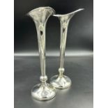 A pair of hallmarked silver candlesticks by A & J Zimmerman Ltd, hallmarked for Birmingham 1906,