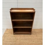 A pine three shelf bookcase with galleried top (H 86cm x D 20cm x W 61cm)