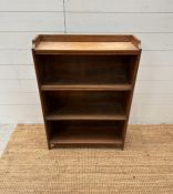 A pine three shelf bookcase with galleried top (H 86cm x D 20cm x W 61cm)