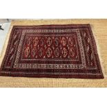 A Persian style red grounds rug 180cm x 117cm