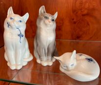 Three Royal Copenhagen china cats two seated, one asleep (H14cm)
