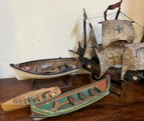 Three model rowing boats and one sailing boat