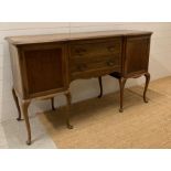 An Oak two drawer, two cupboard sideboard on cabriole legs (H92cm W 50cm D157cm)