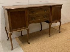 An Oak two drawer, two cupboard sideboard on cabriole legs (H92cm W 50cm D157cm)