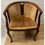 An Edwardian style tub chair on cabriole legs