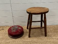 A small oak stool and a red ground floral upholstered foot stool