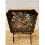 A walnut framed fore screen with needle work to centre