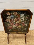 A walnut framed fore screen with needle work to centre