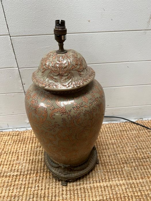 A ginger jar style lamp on a brass base