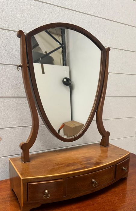 A shield back toilet mirror with three drawers to base (63cm x 41cm)