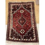 An Iranian carpet red grounds and geometric design 150cm x 102cm