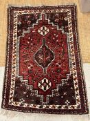 An Iranian carpet red grounds and geometric design 150cm x 102cm