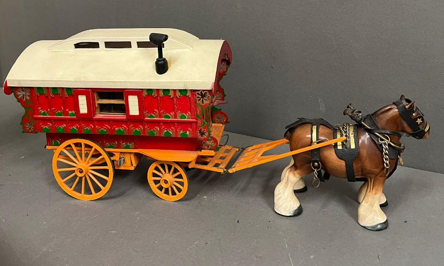 A wooden model of a Gypsy caravan with moving parts and china horse, stamped to base