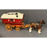 A wooden model of a Gypsy caravan with moving parts and china horse, stamped to base