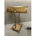 A brass bankers light shade lamp