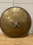 A brass shield with cross detail to centre and stud work (Dia50cm)
