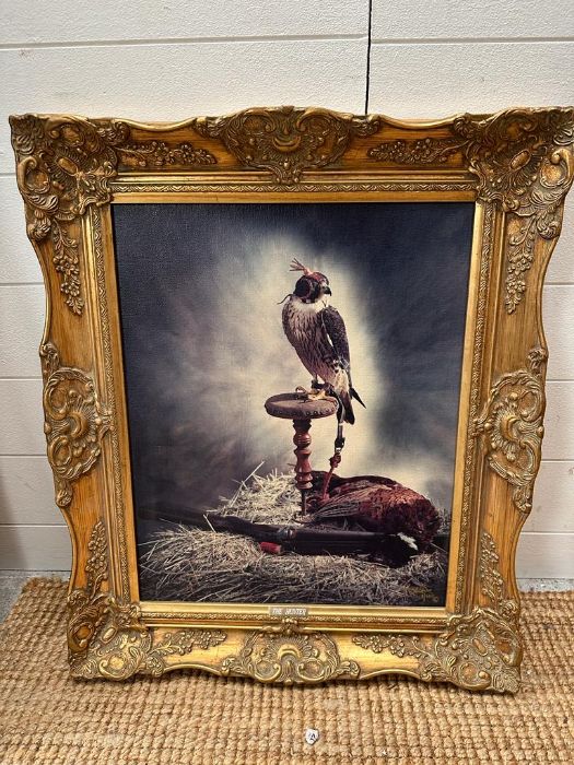 A wooden gold painted framed print on canvas of a hawk titled "The Hunter"