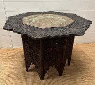 A carved Indian and pattern centre table (H60cm Dia90cm)