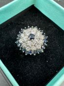 A diamond and sapphire cluster ring on an 18ct white gold setting Size Q