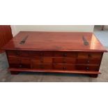 A cherry wood twelve drawer coffee table opening to storage inside (H42cm W118cm D67cm)