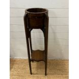 An Arts and Crafts plant stand with metal bound barrel top on tapering legs (H101cm Dia27cm)