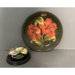 A Moorcroft "Hibiscus" plate and a Moorcroft paperweight