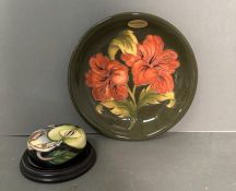 A Moorcroft "Hibiscus" plate and a Moorcroft paperweight