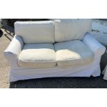 A pair of two seater sofa with loose covers by Oka 74cm High x 150 cm Long x 84cm Deep.