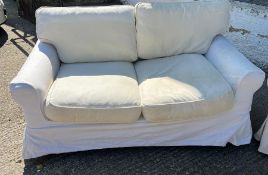 A pair of two seater sofa with loose covers by Oka 74cm High x 150 cm Long x 84cm Deep.