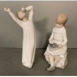 Two Lladro figures- A young boy yawning and a young girl doing homework
