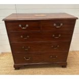 An Edwardian mahogany two over three chest of drawers with string inlay and inlay to top on block