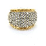 Yellow metal diamond pave set bombe ring with an estimated 2.50 carats. Makers mark CJW and 18K