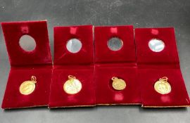 A selection of gold coins mounted as pendants in Asian gold. Two 1912 Half Sovereigns (Approximate