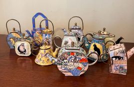 Eleven miniature enamel teapots