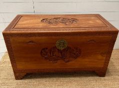 A Camphor chest with Oriental carving depicting boats in a harbour scene with floral boarder ( H