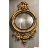 A Regency oval convex mirror in an gilt frame with reclining deer, with silvered finish in