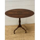 An inlaid oval side table on down swept legs