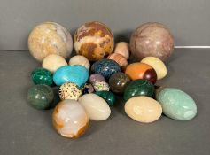 A selection of decorative stone, marble and malachite items in the form of eggs and balls.