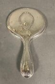 A hallmarked silver vanity mirror.