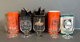 Five boxed commemorative Guinness glasses to include John Gilroy special edition