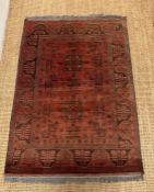 A red ground wool rug with geometric pattern (148cm x 102cm)