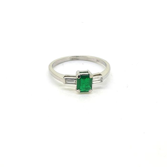 Emerald and diamond three stone ring, central emerald between two baguette diamonds. Emerald